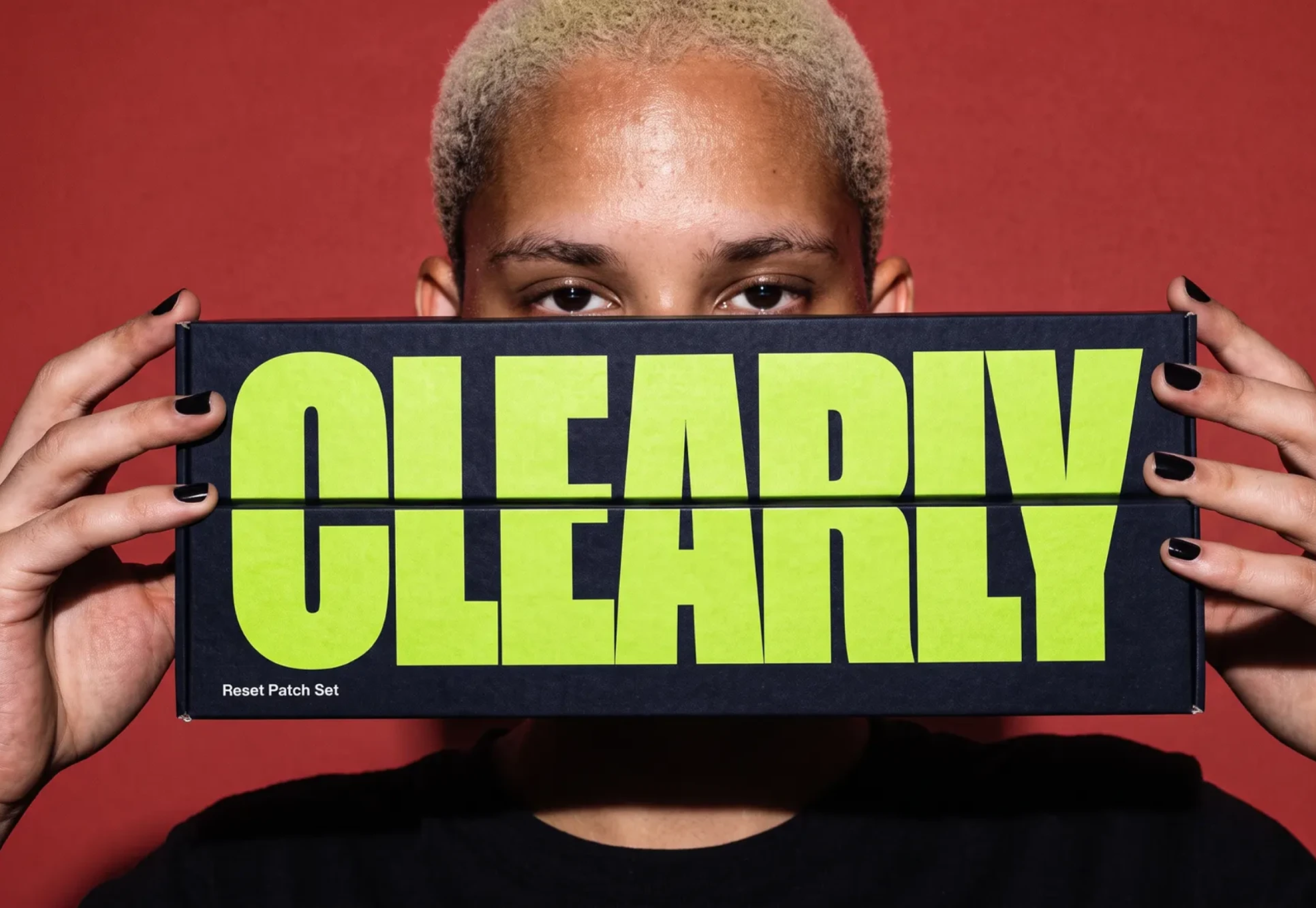 Clearly, a teen holding up a black Clearly box
