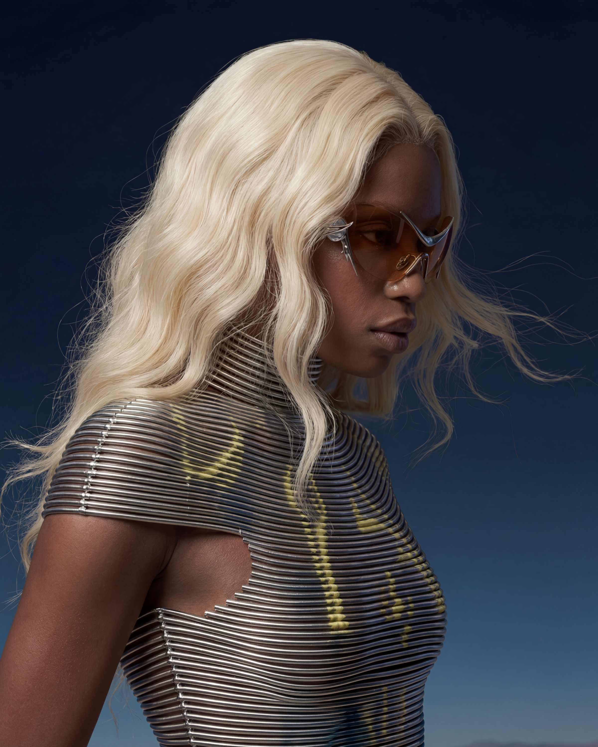 Gentle Moonster, a blonde model in a metallic look and orange-tint glasses