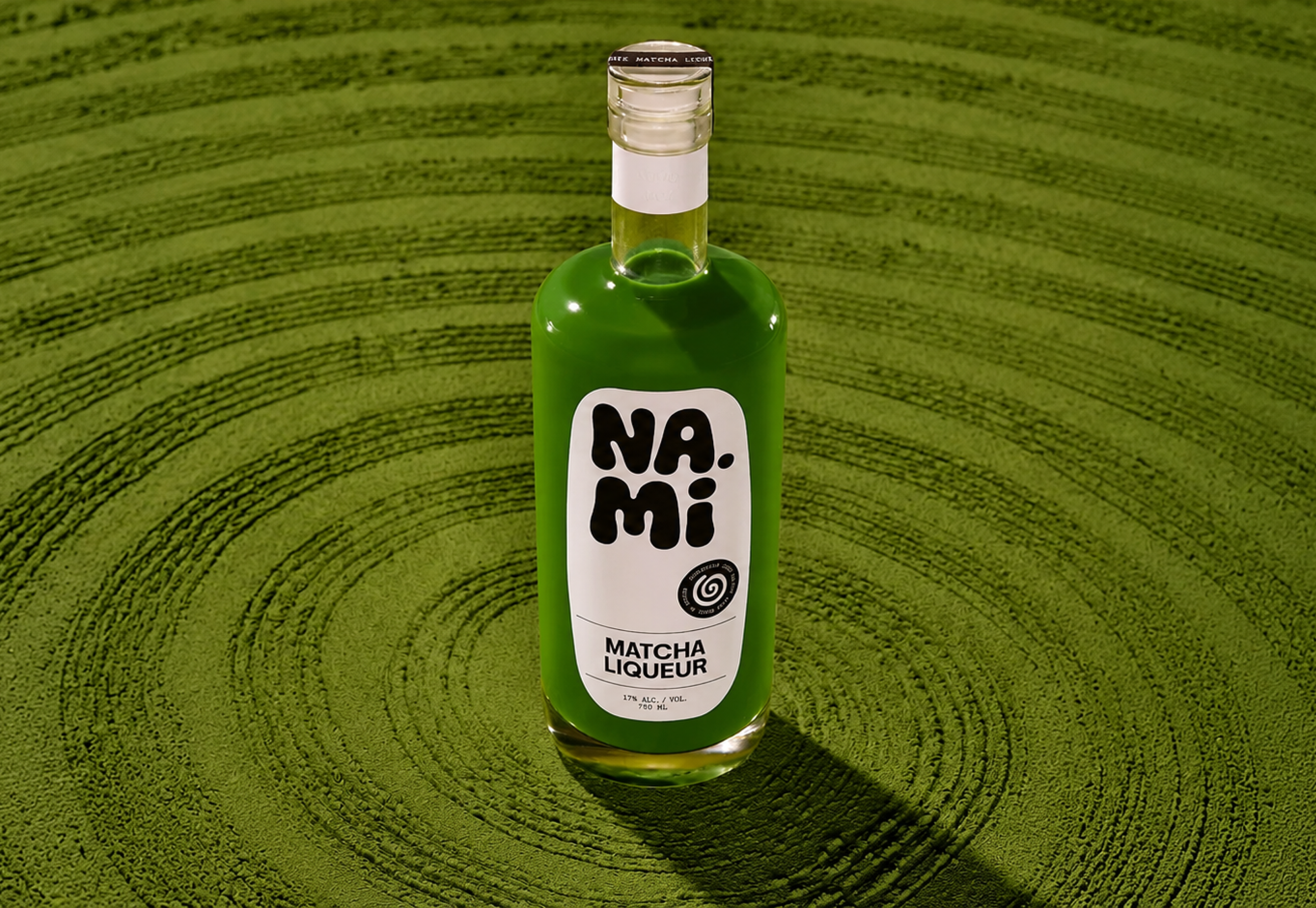 NAMI, a green bottle standing on a swirl of green grass