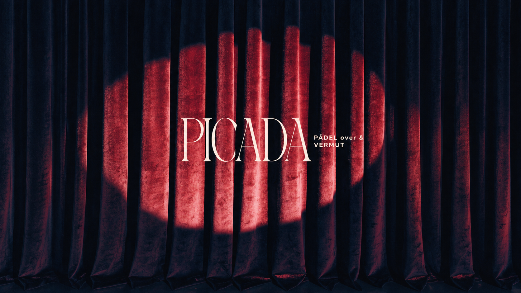 Picada, the logotype in a spotlight on a red velvet curtain